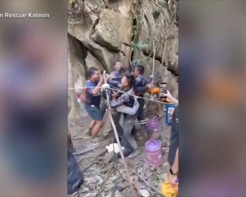 Rescuers free 4 men who had been trapped in a flooded Laos cave, search for 2 still missing